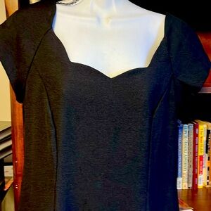 Black straight dress with scallops neckline.